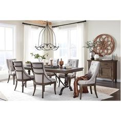 a dining room table with chairs and a chandelier