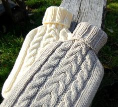 a white knitted mitt sitting on top of a wooden bench