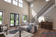 a living room filled with lots of furniture next to a stair case in front of a window