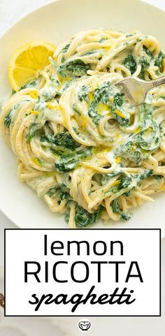 lemon ricotta spaghetti with spinach and parmesan cheese in a white bowl