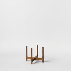 a small wooden table with two legs on one side and another leg on the other