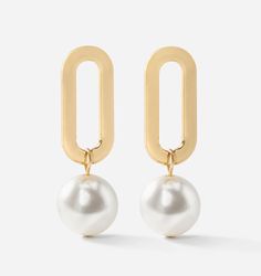 Versatile enough to be paired with off-duty looks or dressed up for special occasions, these Gold & Pearl Droplet Earrings are the statement pair you've been looking for. Both elegant and bold, these gold droplet earrings features an oval high-shine gold design with a glimmering white drop pearl. 18K Gold Plated Over 50% Zinc Alloy, 50% Faux Pearl. Keep jewelry clean, store in a separate pouch. Luxury Classic Earrings With Spring Ring Clasp, Luxury Timeless Yellow Gold Pearl Earrings, Luxury Small Hoop Yellow Gold Pearl Earrings, Luxury Yellow Gold Pearl Earrings In Brass, Luxury Refined Yellow Gold Pearl Earrings, Luxury Yellow Gold Huggie Earrings With Pearl Drop, Luxury Yellow Gold Pearl Earrings For Festivals, Shine Jewelry, Droplet Earrings