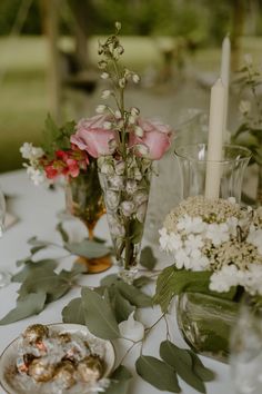 the table is set with flowers and candles