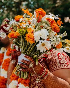 the bride and groom are holding flowers in their hands