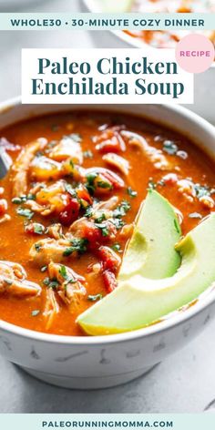 a bowl of chicken enchilada soup with an avocado on the side