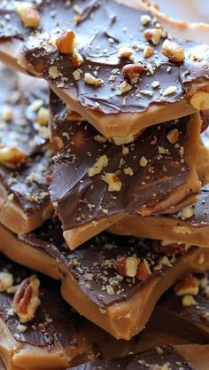 there are many pieces of chocolate with nuts on top