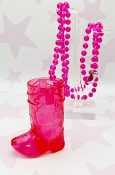 a pair of pink rain boots and beaded bracelets are on display in front of a star - patterned background