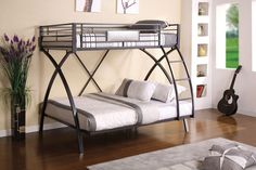 a bunk bed with a metal frame and mattresses on top of it in a room