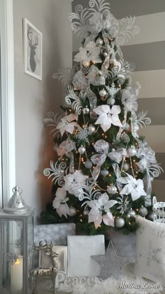 a christmas tree with white and silver decorations