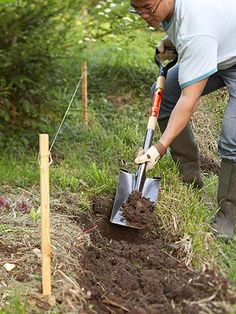 a man digging in the ground with a shovel