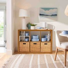 a dining room with white walls and blue dishes on the shelves in front of it