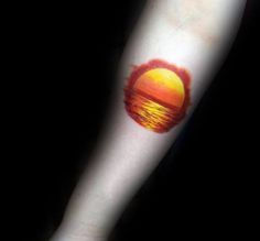 a sunset on the arm with red lipstick