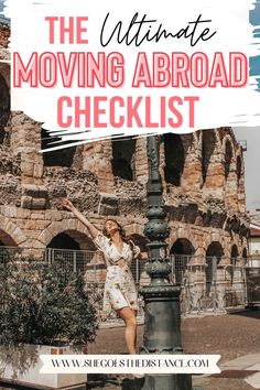 a woman standing on top of a light post in front of an old building with text overlay reading the ultimate moving abroad checklist