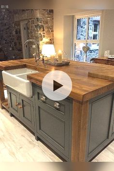 a kitchen with an island and sink in the center, surrounded by stone fireplaces