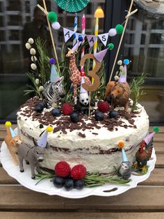 a birthday cake decorated with animals and decorations