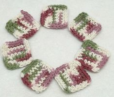 six crocheted squares are arranged in a circle