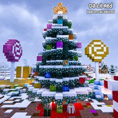 a christmas tree made out of lego blocks in the middle of a snowy field with presents on it