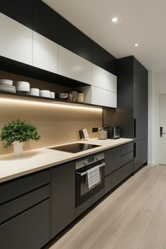 a modern kitchen with black cabinets and white counter tops is lit by recessed lighting