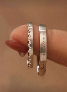 two silver rings with white diamonds on each one and the words, you are loved