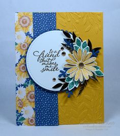 a close up of a greeting card with flowers on the front and bottom, along with an embellishment