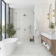 a bathroom with a large tub and two sinks