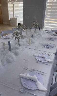 the table is set with white linens and place settings