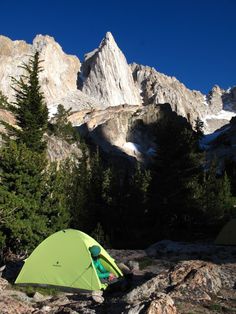 a tent pitched up on the side of a mountain