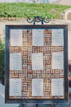 a cork board with seating cards attached to it