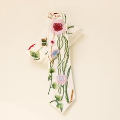 Match with your bride! This white necktie features a bit of the wildflower embroidered tulle sewn on top, along with cutouts of flowers glued on to help cover up any gaps in the design.  The decoration portion is about 20" long.  -- WG Adjustable Suit And Tie Accessories For Summer Wedding, White Ties For Groom In Spring, White Summer Tie For Groom, White Suit And Tie Accessories For Groom In Summer, White Suit And Tie Accessories For Summer Wedding, Floral Tie Groom, Groom Tie, Flower Tie, Groom Ties