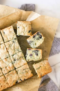 blueberry scones cut into squares on a piece of parchment paper