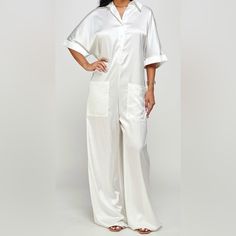 White Oversized Silk Jumpsuit With Pockets & Button Front Button Closure Jumpsuits And Rompers For Loungewear, Jumpsuits And Rompers With Button Closure For Loungewear, Solid Button-up Jumpsuits For Loungewear, Solid Color Button-up Jumpsuits For Loungewear, White Wide-leg Jumpsuits For Loungewear, White Wide Leg Jumpsuits And Rompers For Loungewear, White Wide Leg Jumpsuits For Loungewear, Relaxed Fit Button-up Jumpsuits And Rompers For Loungewear, Solid Relaxed Fit Jumpsuits And Rompers For Daywear