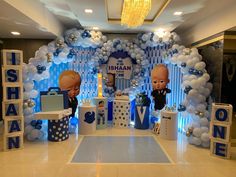 the entrance to an event decorated with balloons and decorations