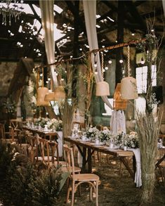 the tables are set up for an outdoor wedding reception with white flowers and greenery