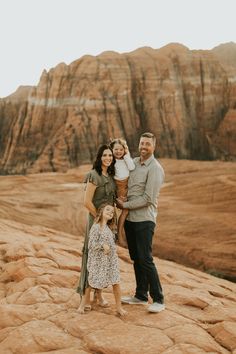 a family standing on top of a rock formation