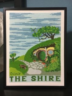 a cross stitch picture with the words the shire on it