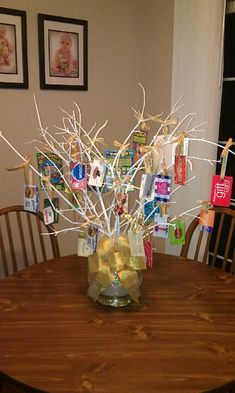 a vase filled with branches sitting on top of a wooden table