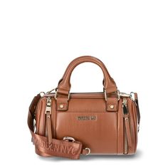 This Madden NYC Women's Multi Zipper Barrel Bag in Cognac is the perfect addition to your Fall wardrobe! This bag is 100% polyurethane and has a zipper closure for the main compartment. The interior features a zipper pocket on the back wall. The exterior has slip pocket on the front wall with a double zippered detail on both sides. There is a also a small zipper pouch that can be removed from the crossbody strap. The crossbody strap has Madden NYC logo embroidered detailing and clips on both sides to be completely removed if you prefer to carry the bag by the double top handles. This is a classic bag that you'll not only want use all Fall, but all year 'round! Size: one size.  Color: Brown.  Gender: female.  Age Group: adult. Brown Canvas Satchel With Zipper Closure, Brown Leather Bag With Metal Zipper, Trendy Brown Satchel With Zipper Closure, Cognac Satchel With Zipper Closure For Daily Use, Chic Cognac Bag With Zipper Closure, Cognac Rectangular Satchel With Zipper Closure, Cognac Satchel Bag With Zipper Closure, Rectangular Cognac Satchel With Zipper Closure, Brown Crossbody Satchel With Zipper Closure