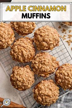 apple cinnamon muffins on a cooling rack with cinnamon sticks and apples in the background