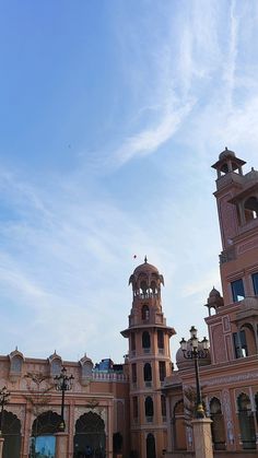 a large building with two towers on the top and one at the bottom in front of it