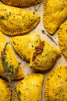 several pastries with herbs and seasoning on top