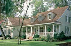 a white house with lots of windows in the front yard