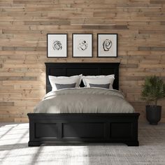 a bedroom with wood paneling on the wall and bed in it, along with potted plants