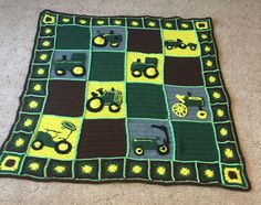 a crocheted blanket with tractors on it