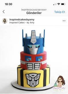 a three tiered cake decorated like the transformer from toy story books is displayed