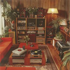 a living room filled with lots of different types of furniture and electronics on top of each other