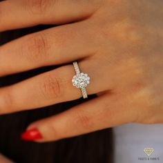 a woman's hand with a diamond ring on it