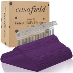 a purple hanger sitting next to a cardboard box