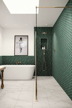 a bathroom with green and white tiles on the walls, a bathtub, and a sink