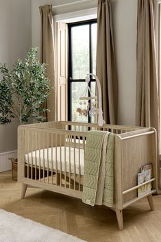 a baby's crib in front of a window