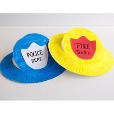 two paper plates with fire department hats on them